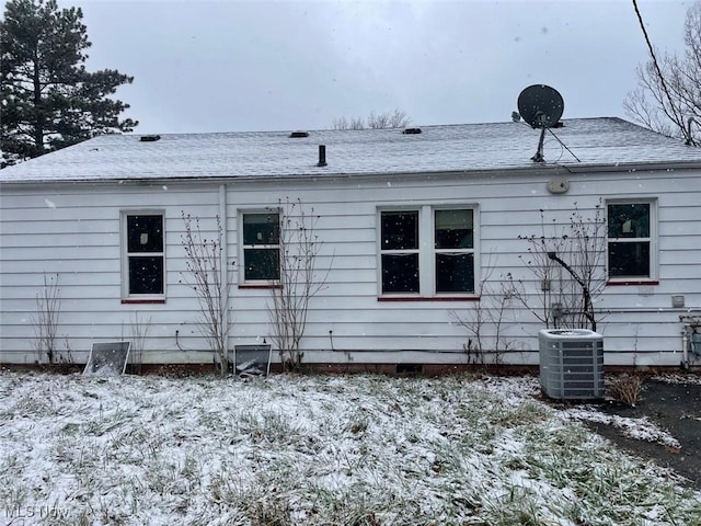 snow covered property featuring cooling unit