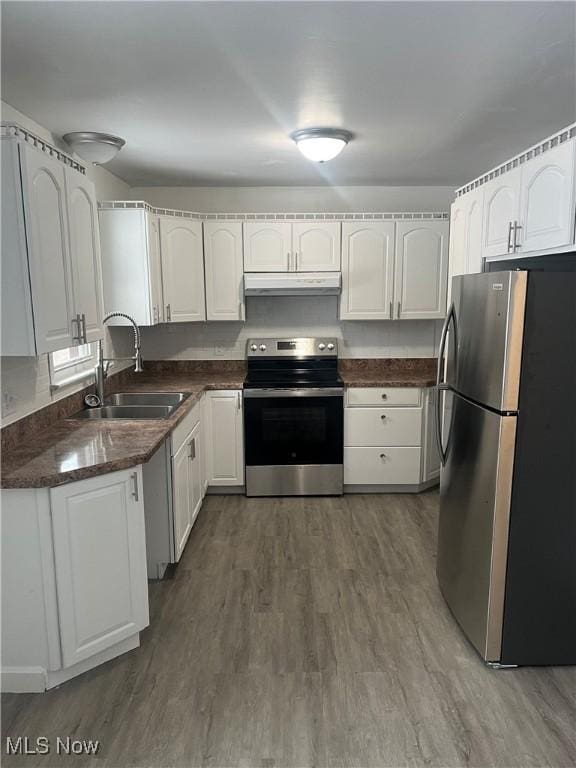 kitchen with white cabinets, dark hardwood / wood-style floors, sink, and appliances with stainless steel finishes