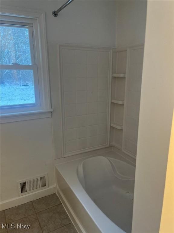 bathroom with shower / washtub combination and tile patterned flooring