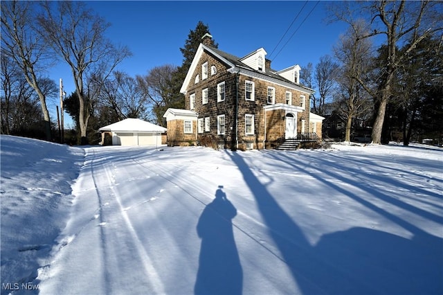 view of front of property with a garage and an outdoor structure