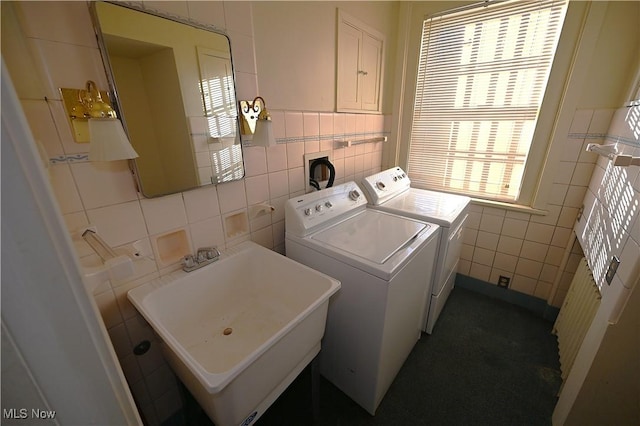 washroom with sink, hookup for a washing machine, and tile walls