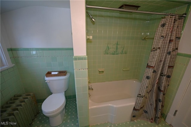 bathroom featuring radiator, toilet, tile walls, and shower / bath combination with curtain