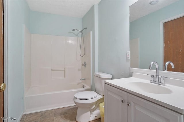 full bathroom featuring vanity, toilet, shower / tub combination, and a textured ceiling