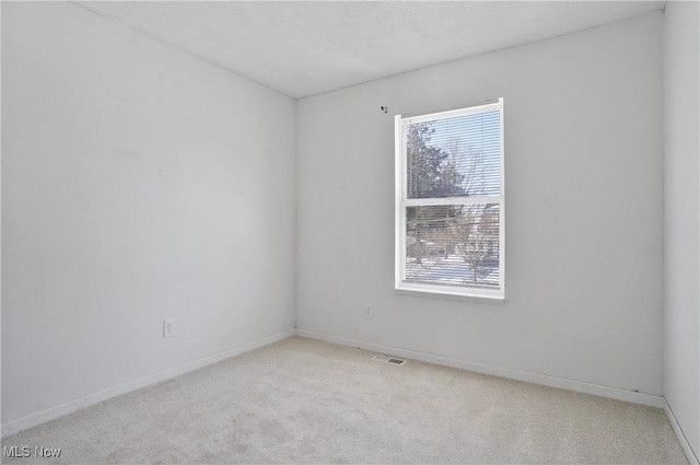 spare room with light carpet