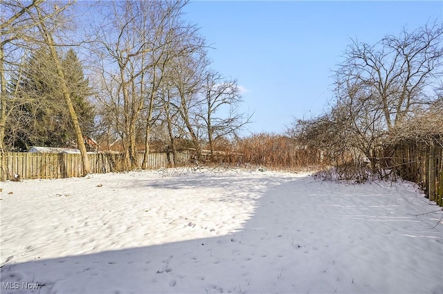 view of yard layered in snow