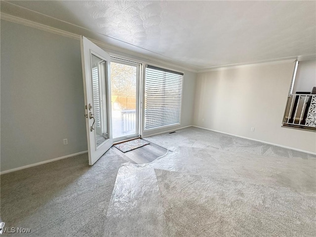 spare room featuring ornamental molding and light carpet