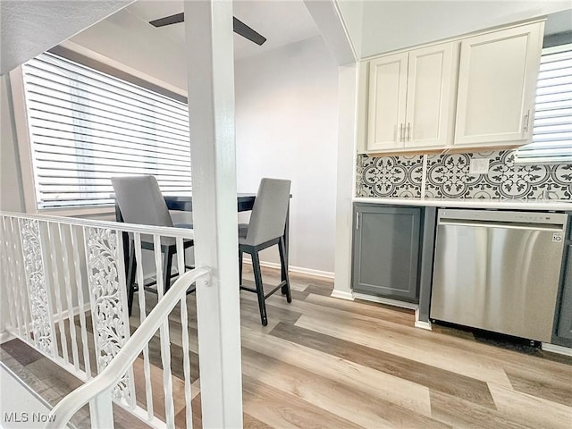 kitchen with ceiling fan, dishwasher, light hardwood / wood-style floors, and plenty of natural light