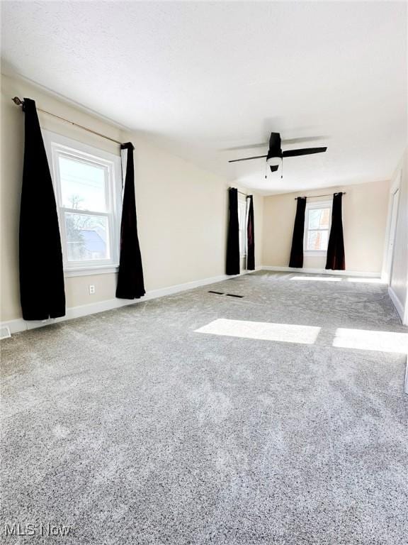 empty room featuring ceiling fan and carpet floors