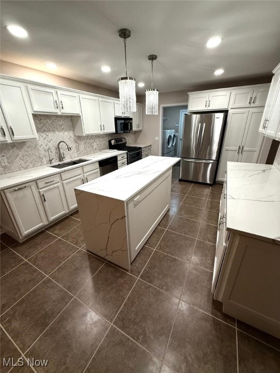 kitchen with stainless steel appliances, sink, pendant lighting, white cabinets, and a center island