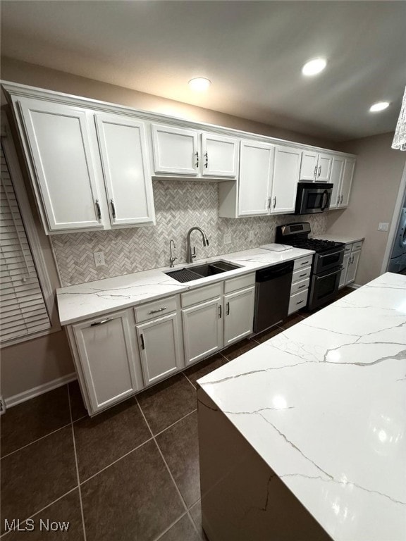 kitchen with white cabinets, dishwashing machine, double oven range, and sink