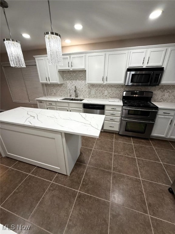 kitchen featuring pendant lighting, sink, white cabinets, and stainless steel appliances