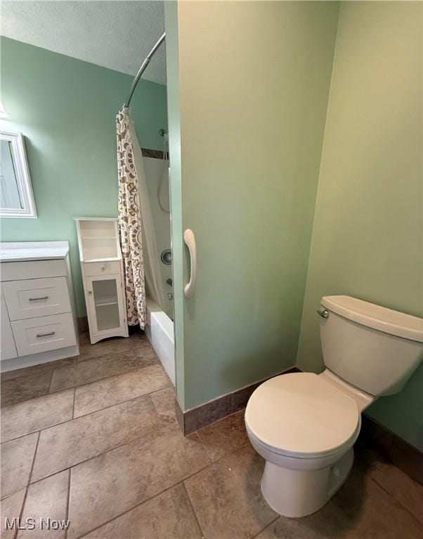 full bathroom featuring toilet, vanity, shower / bath combination with curtain, and a textured ceiling