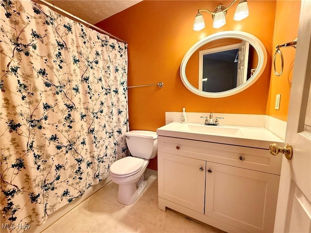 bathroom featuring toilet, vanity, tile patterned floors, and a textured ceiling