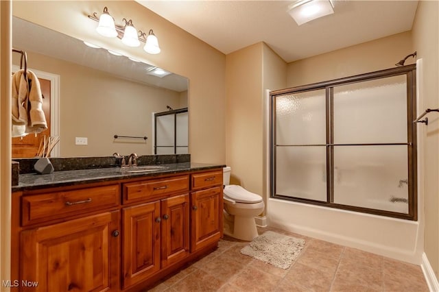 full bathroom featuring combined bath / shower with glass door, vanity, and toilet