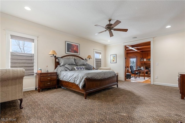 carpeted bedroom with multiple windows, ceiling fan, and crown molding