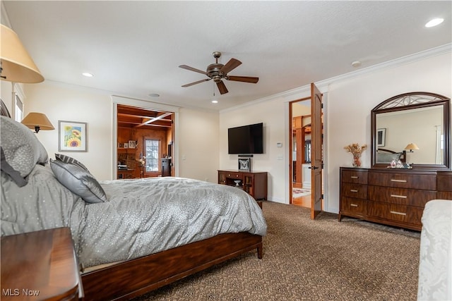 carpeted bedroom featuring ensuite bathroom, ceiling fan, and ornamental molding