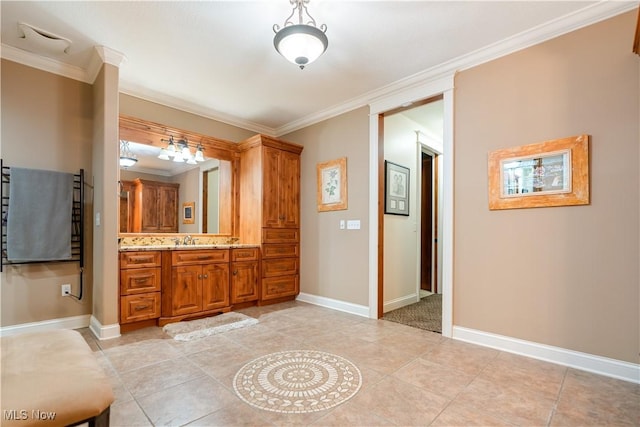 bathroom featuring tile patterned flooring, vanity, and ornamental molding