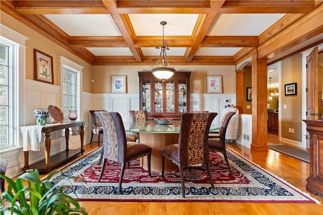 dining room with beamed ceiling, wood-type flooring, decorative columns, and coffered ceiling