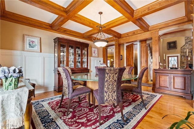 dining space featuring hardwood / wood-style floors, beam ceiling, and coffered ceiling