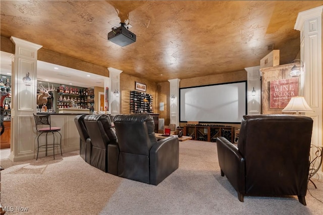 carpeted home theater with indoor bar