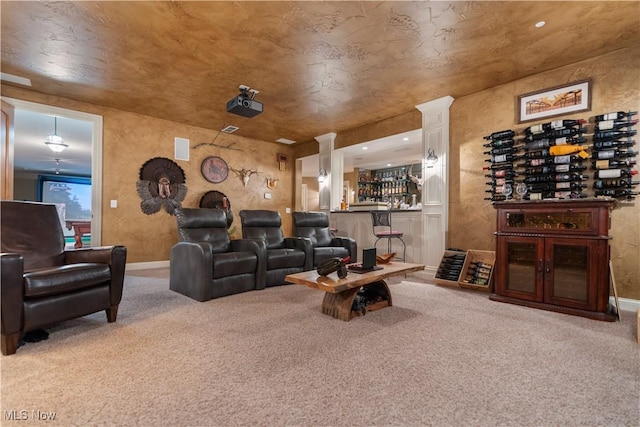 carpeted home theater featuring bar