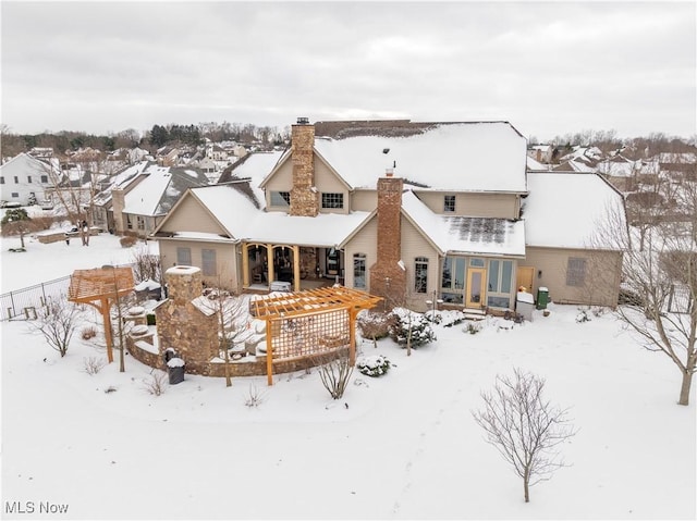 view of snow covered rear of property