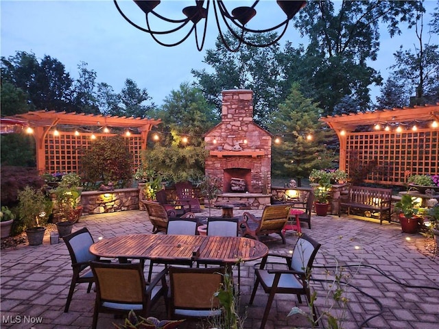 patio terrace at dusk with an outdoor stone fireplace