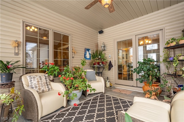 sunroom with ceiling fan and wooden ceiling