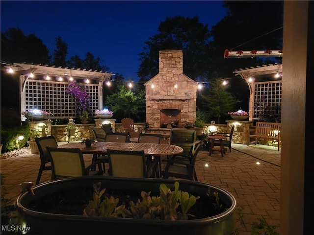 patio at night with an outdoor stone fireplace