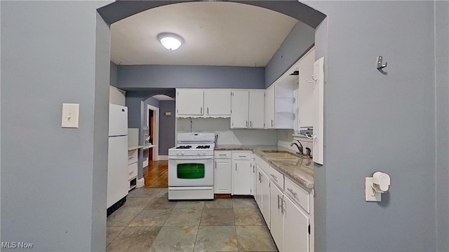 kitchen featuring white cabinets, white appliances, and sink