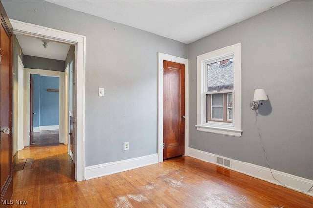 unfurnished bedroom with hardwood / wood-style flooring