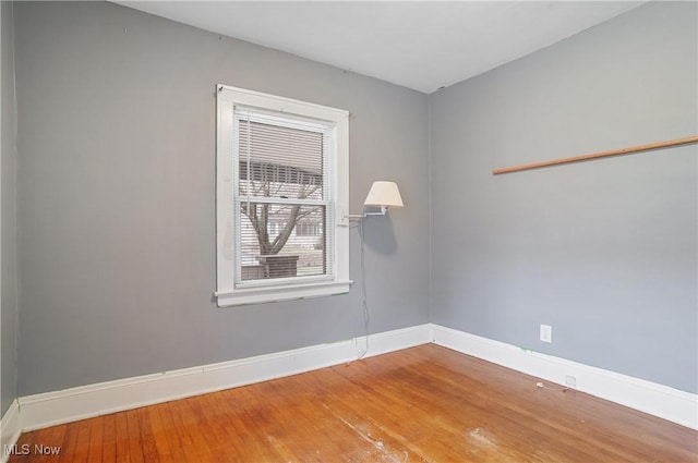 unfurnished room with hardwood / wood-style flooring