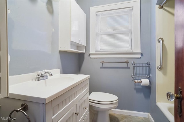 bathroom with tile patterned floors, vanity, toilet, and a tub