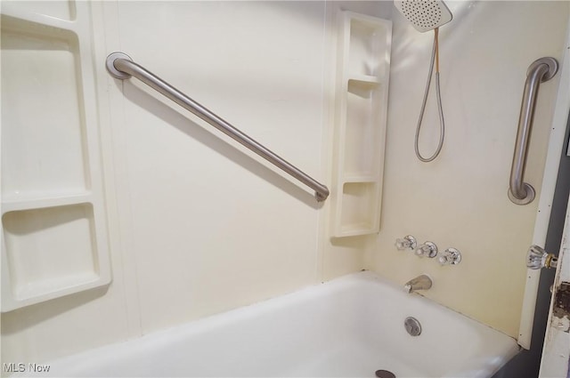 bathroom with bathing tub / shower combination