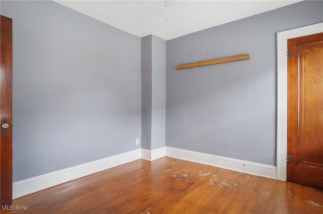 unfurnished room with hardwood / wood-style flooring