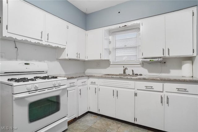 kitchen featuring white cabinets, sink, and white range with gas cooktop