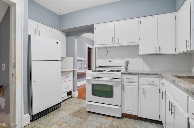 kitchen with white appliances and white cabinetry