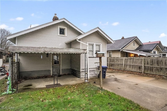 rear view of property featuring a yard