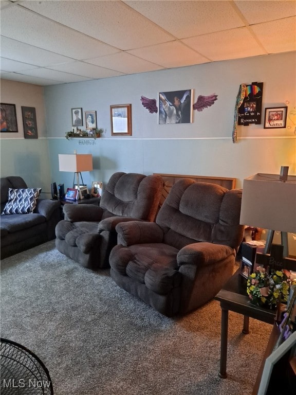 living room with carpet and a drop ceiling