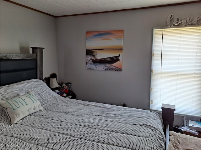 bedroom with multiple windows and crown molding