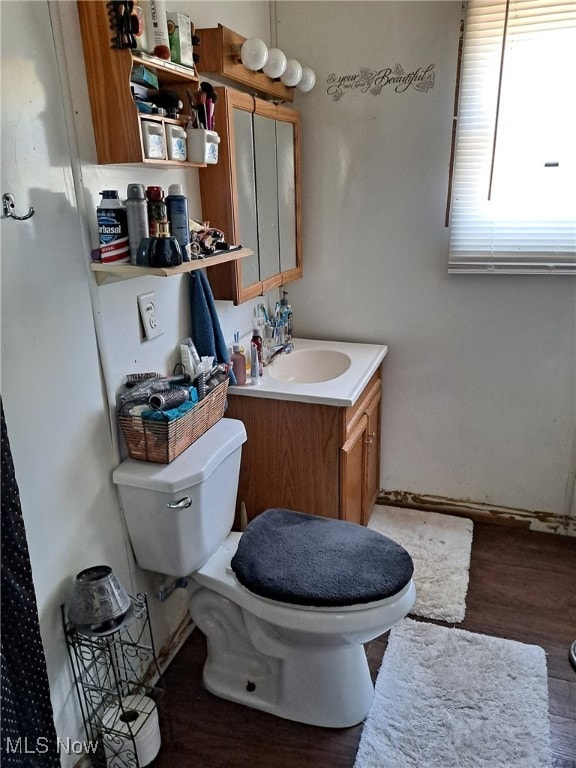 bathroom featuring vanity, hardwood / wood-style flooring, and toilet