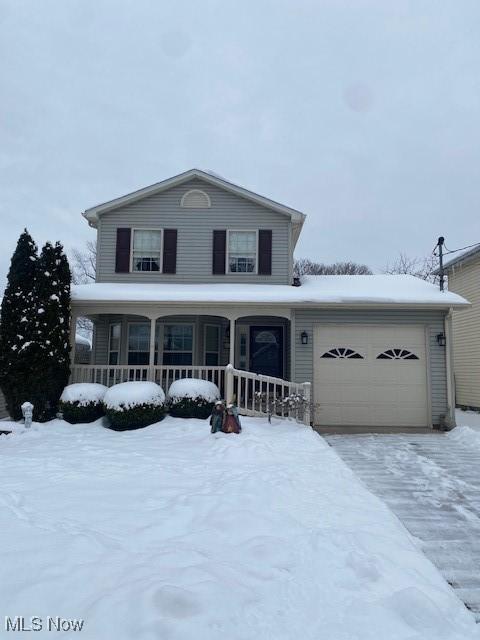 view of front of house with a porch and a garage