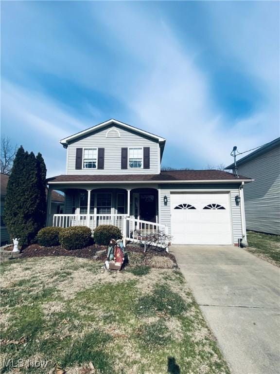 traditional home with a garage, driveway, a porch, and a front lawn