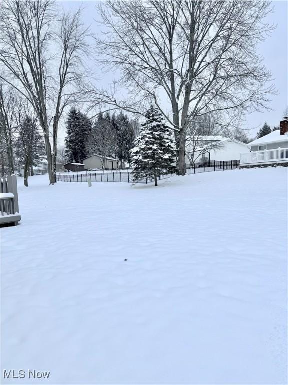 view of yard layered in snow