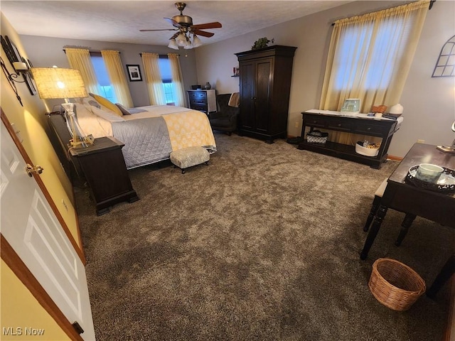 bedroom featuring dark colored carpet and ceiling fan