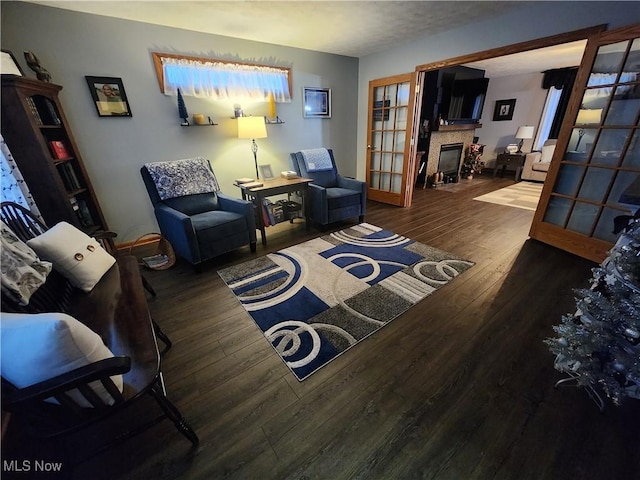 living room featuring a textured ceiling, french doors, and dark hardwood / wood-style floors