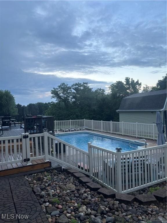 view of pool with a wooden deck