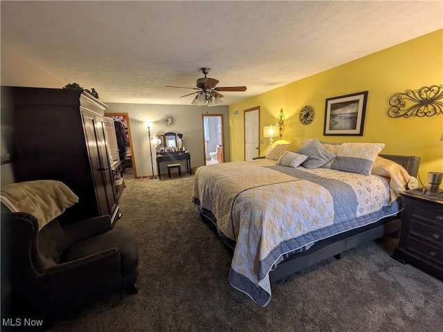 carpeted bedroom featuring ceiling fan and a textured ceiling