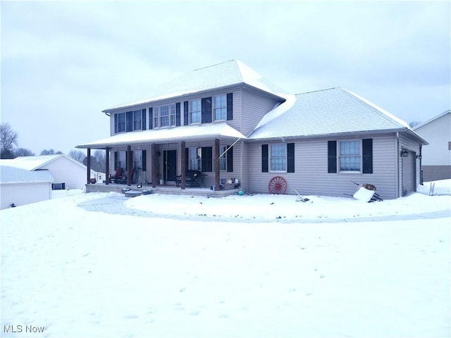 view of front of home featuring covered porch and a garage