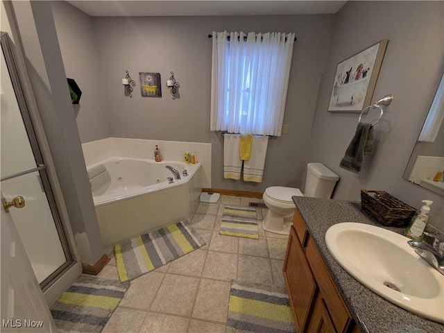 bathroom with vanity, toilet, and a tub